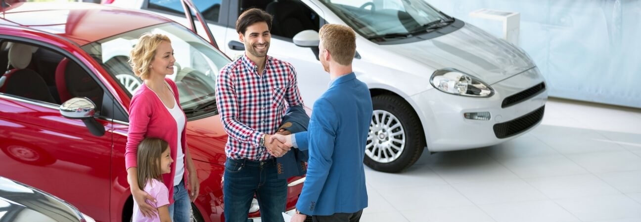 A car dealer using car sales tools on a tablet to manage inventory efficiently.