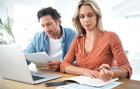 Couple reviewing car refinance options