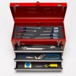 Comprehensive tool set including wrenches, sockets, and pliers, essential for changing a car battery safely and efficiently.