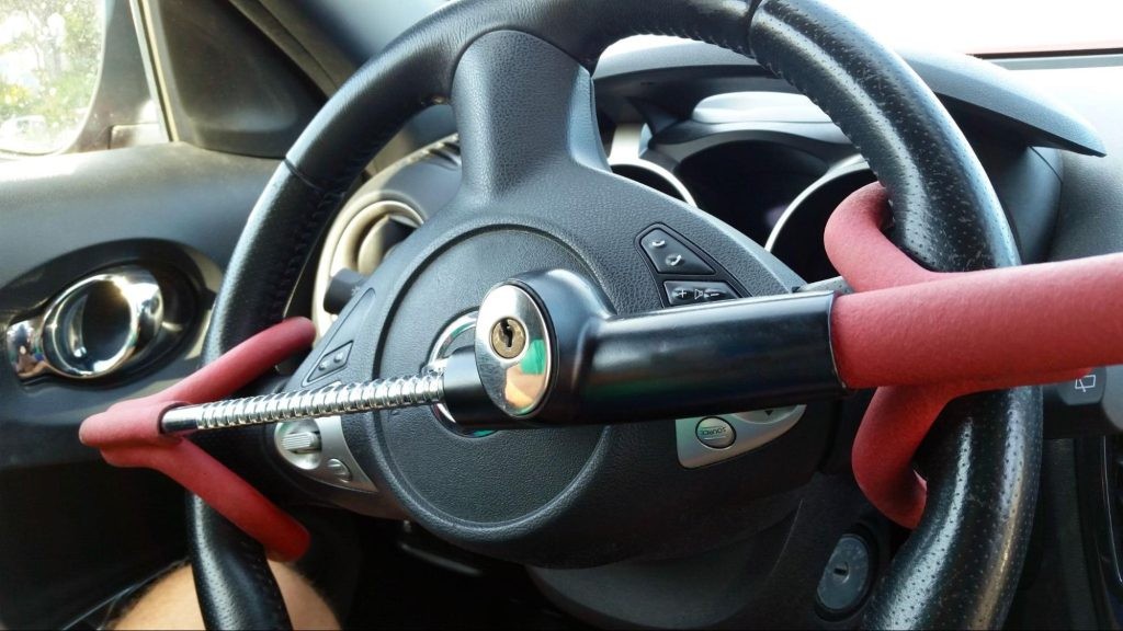 Steering wheel secured with a red lock.