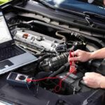 mechanic using diagnostics tools on a car